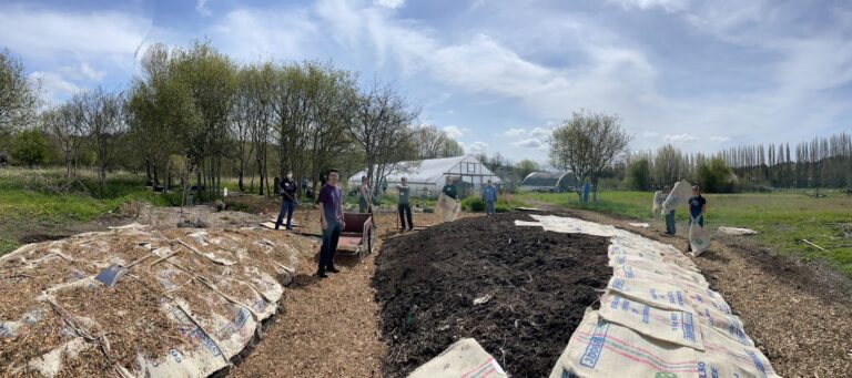 volunteers with hugelkultur beds in spring 2022